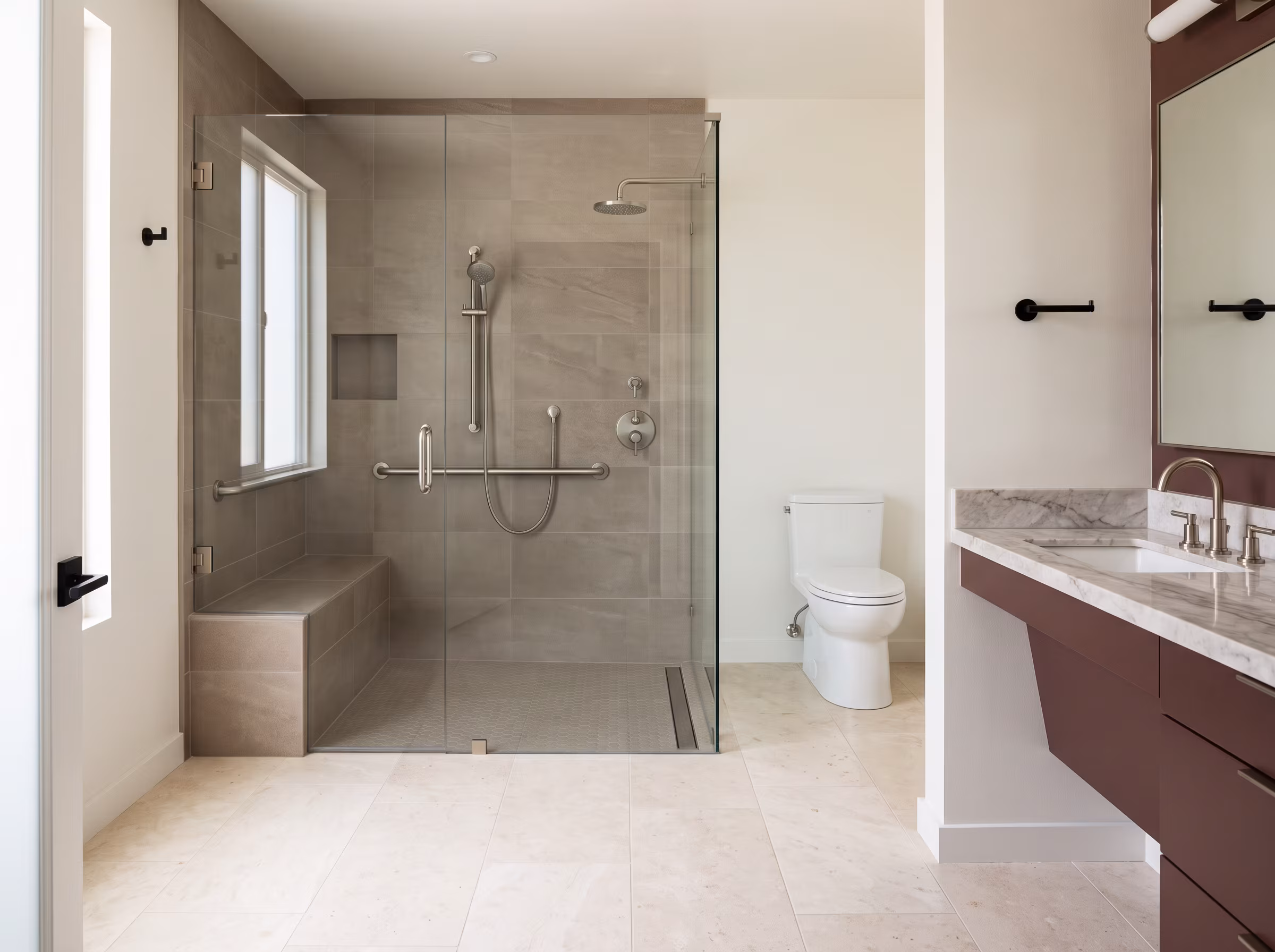 Low-threshold walk-in shower with a tiled bench and glass enclosure