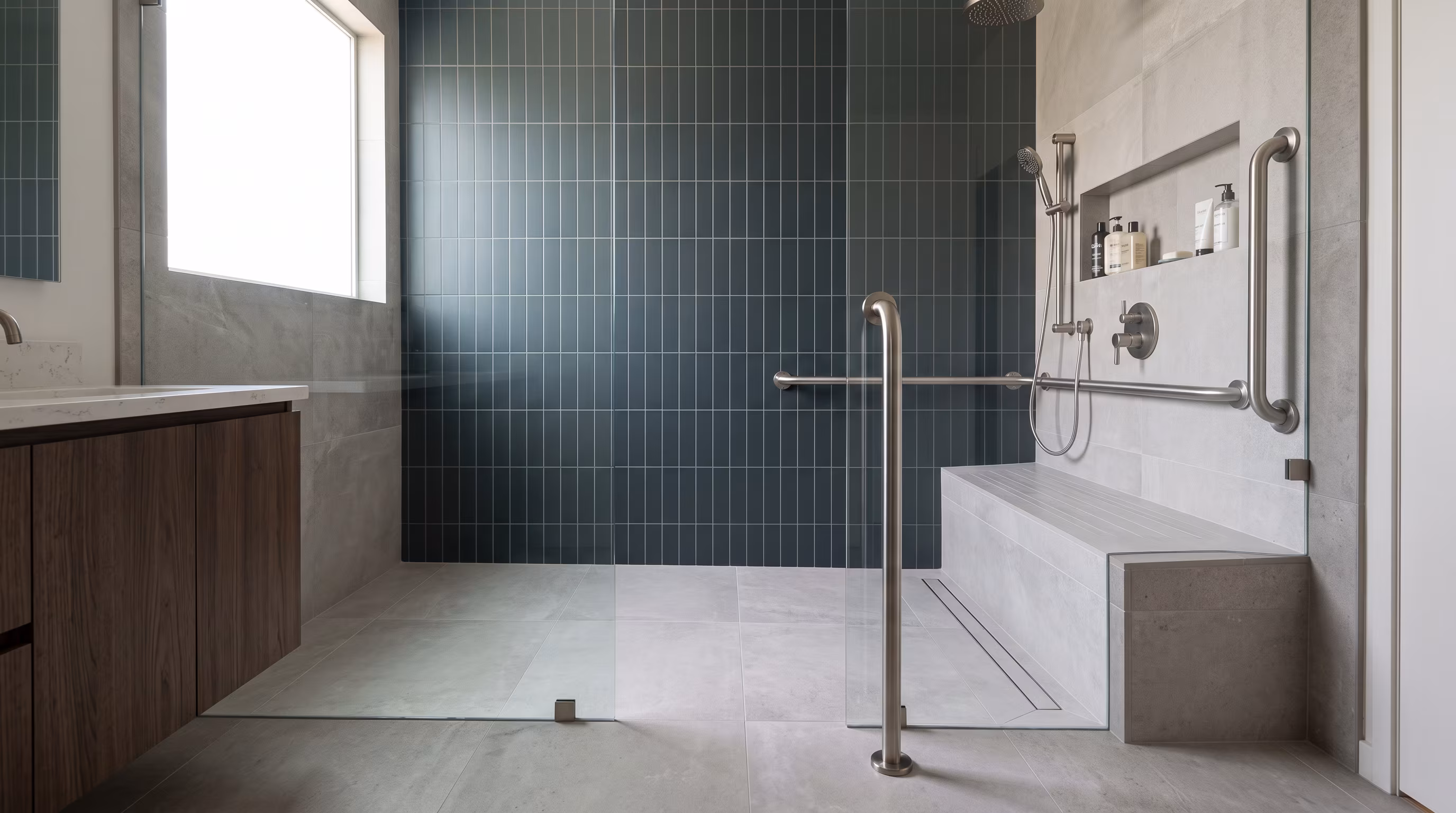 Accessible corner shower with a low entry, grab bar and recessed niche