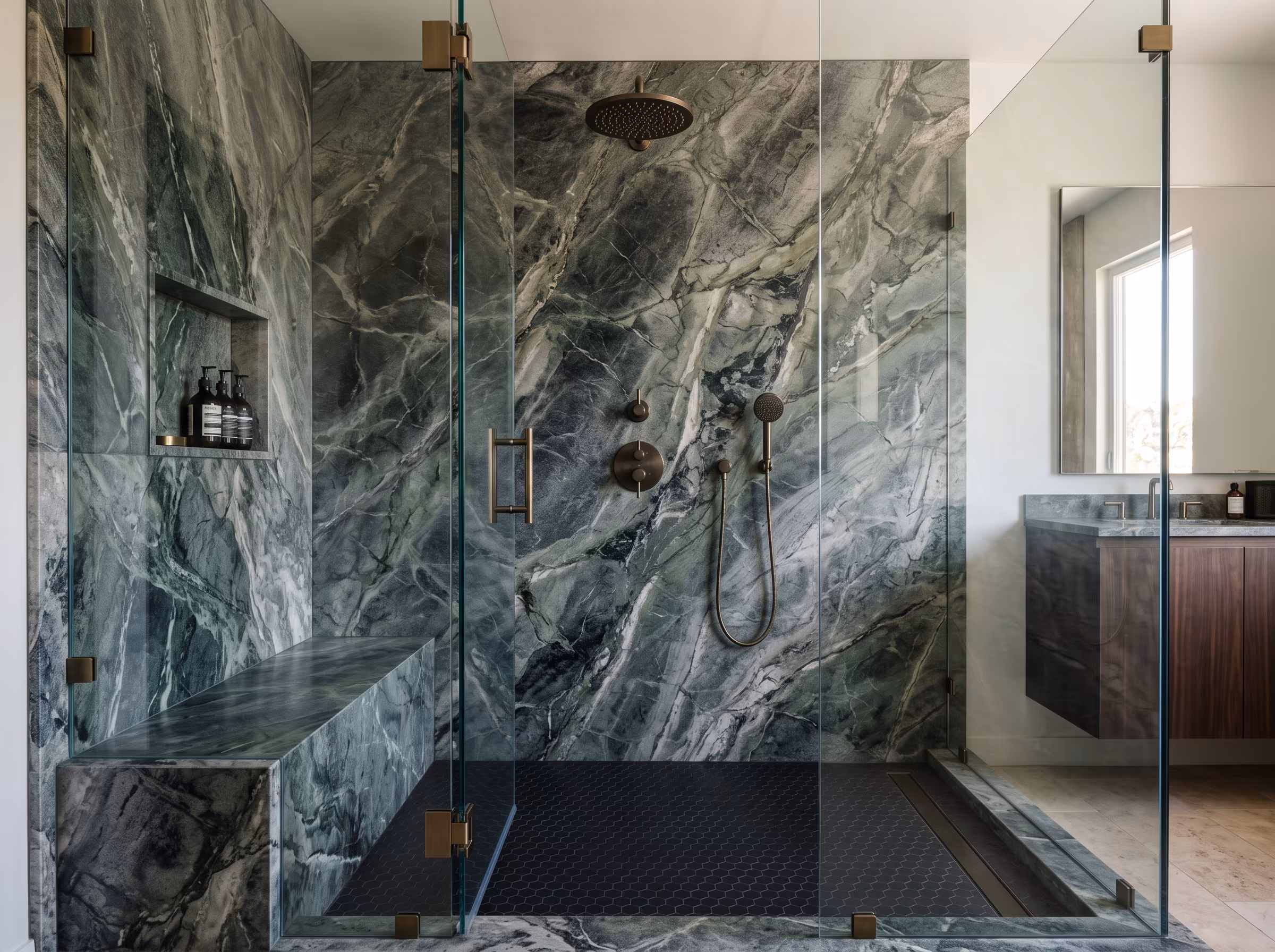 Natural stone tiled shower with distinctive variation and a pebble floor