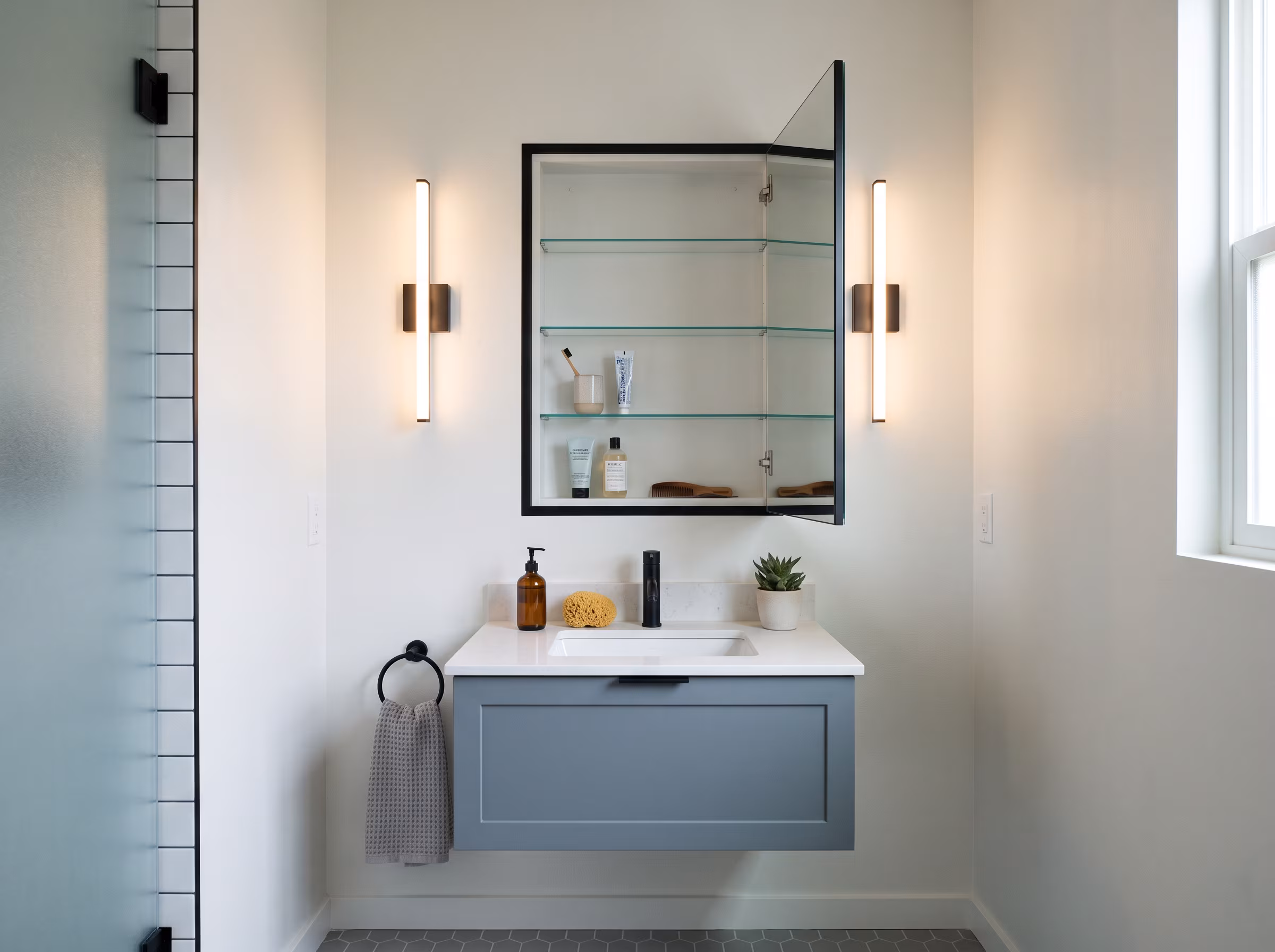 Walk-in shower and compact vanity showing improved circulation