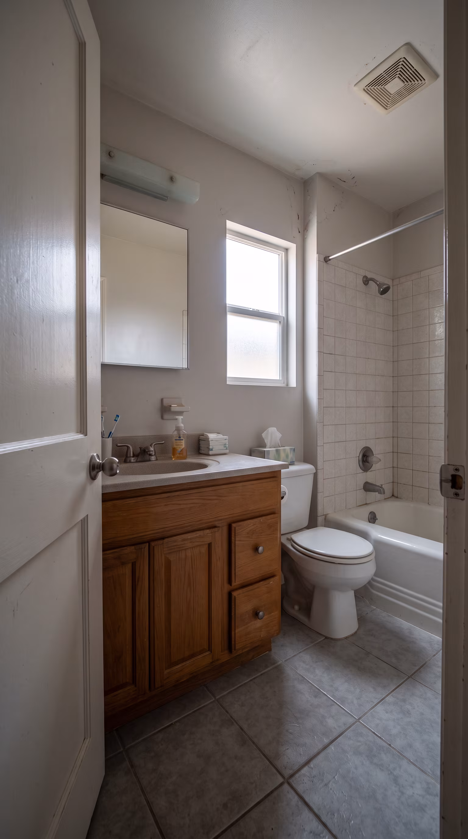 Compact bathroom with floating vanity and walk-in shower