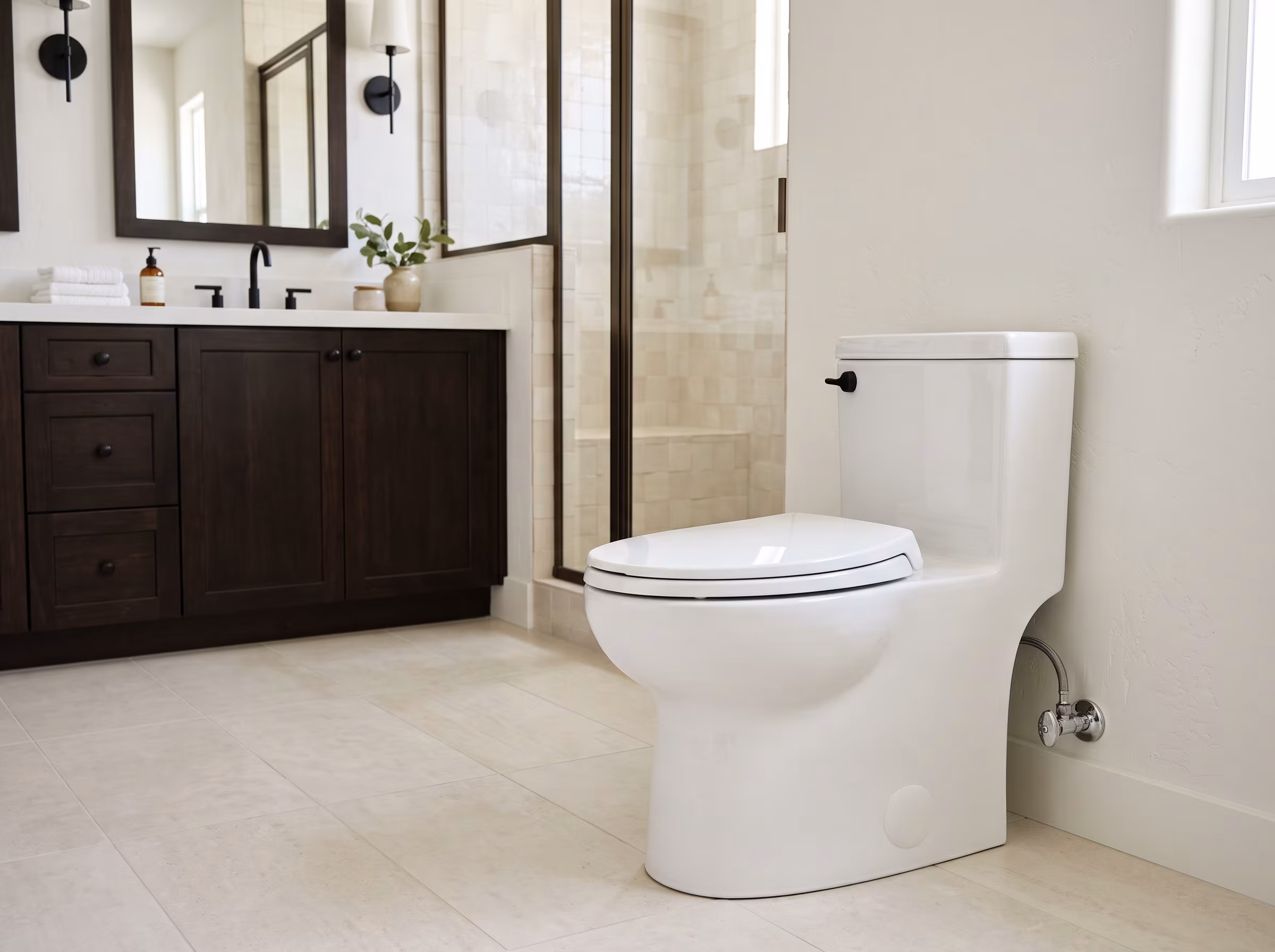 Sleek one-piece wall-hung toilet and matching bidet in a marble bathroom